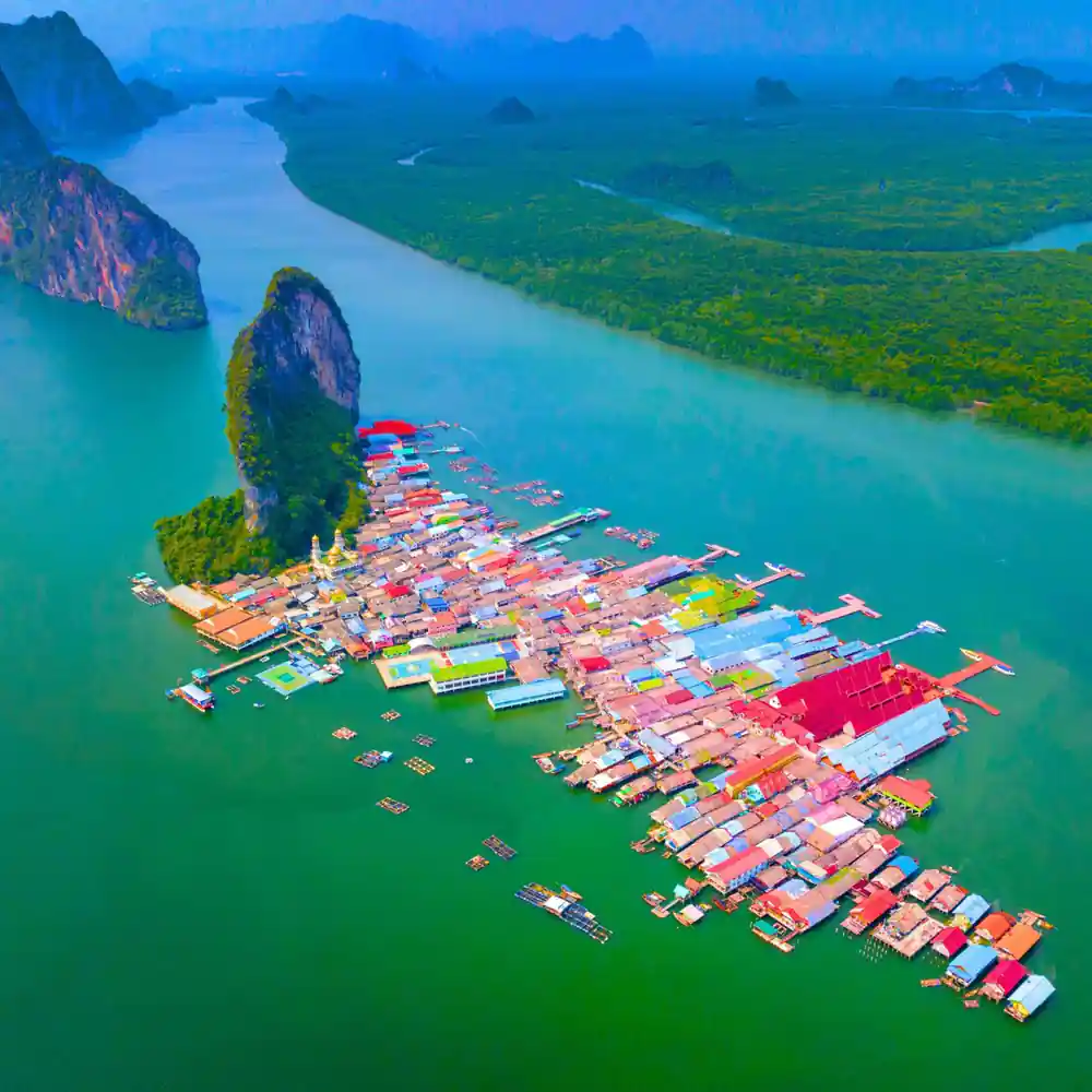 Aerial view of colorful floating houses on turquoise water