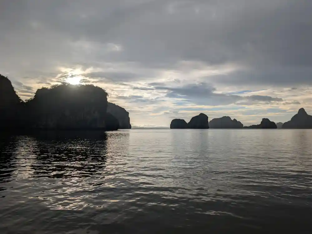 Dramatic limestone karst islands at dusk with still water