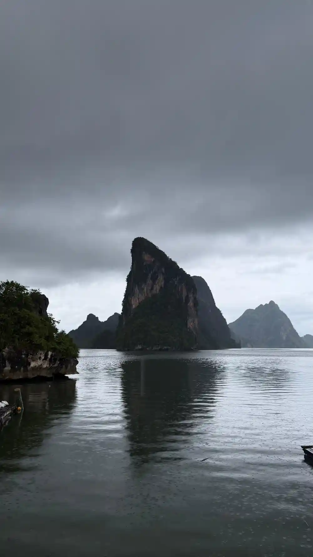 Dramatic limestone rock formations rising from calm sea