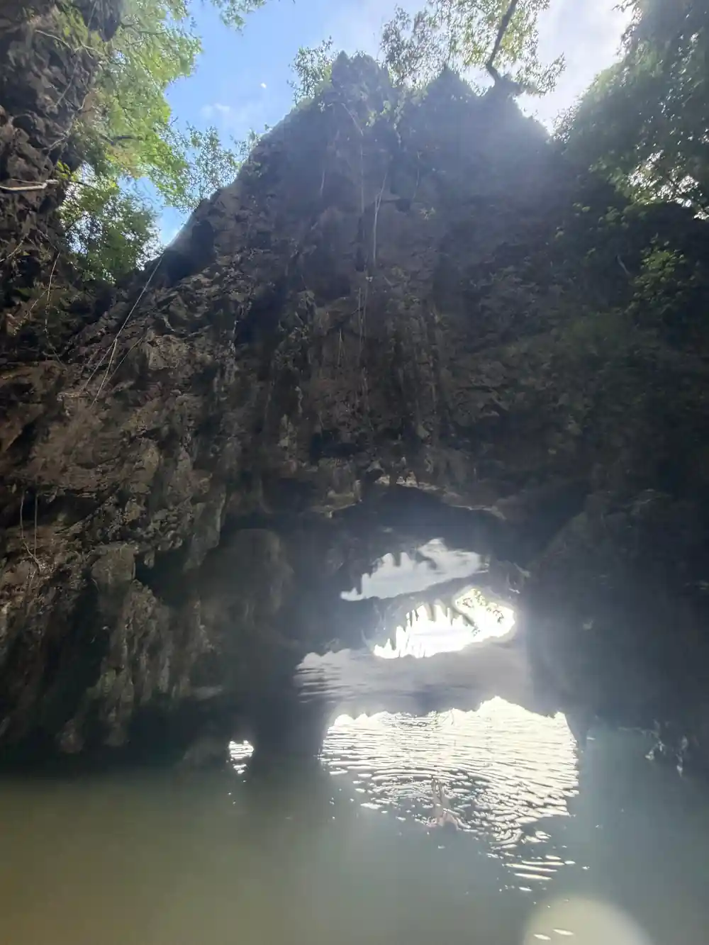 Golden temple with limestone cliff backdrop on water