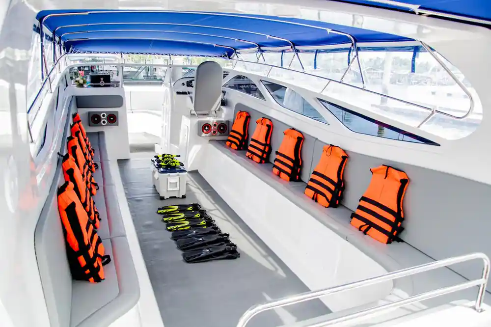 Speedboat interior with orange life jackets and equipment
