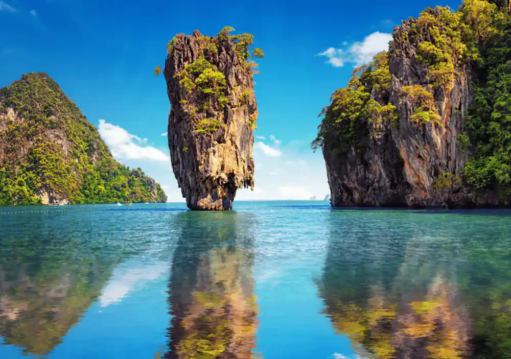 Tall limestone rock formations rising from turquoise water