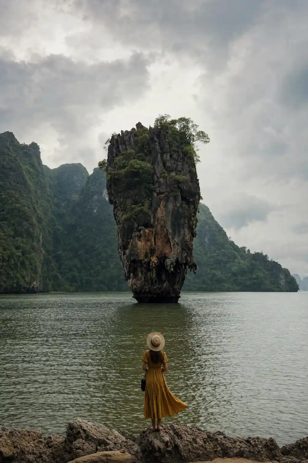Tall steep-sided limestone island in shallow turquoise water
